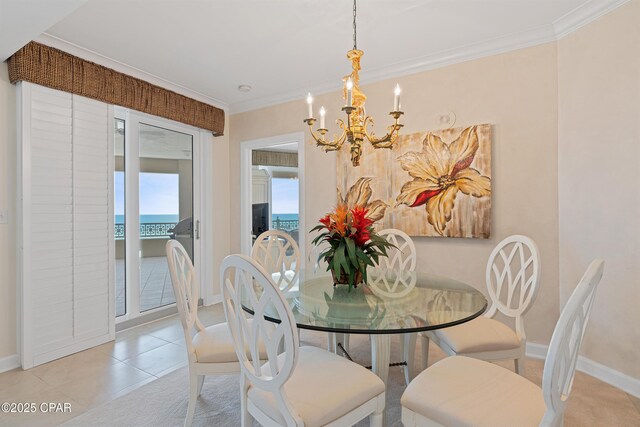 7505 Thomas Dr Unit 523C, Panama City Beach, FL 32408 - dining space with ornamental molding, a notable chandelier, a water view, and baseboards