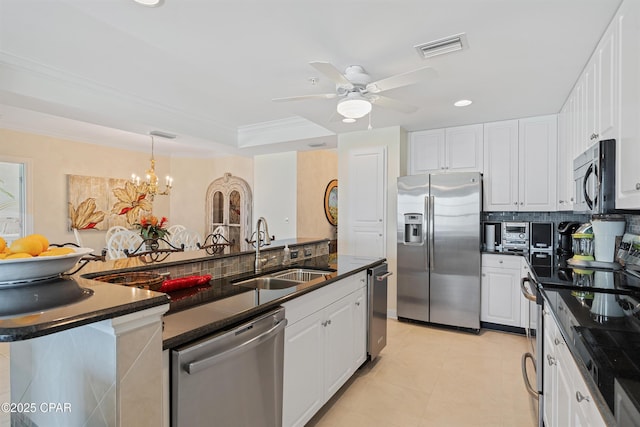 kitchen featuring stainless steel appliances, a sink, visible vents, white cabinets, and dark countertops