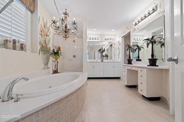 bathroom with a jetted tub, vanity, and tile patterned floors