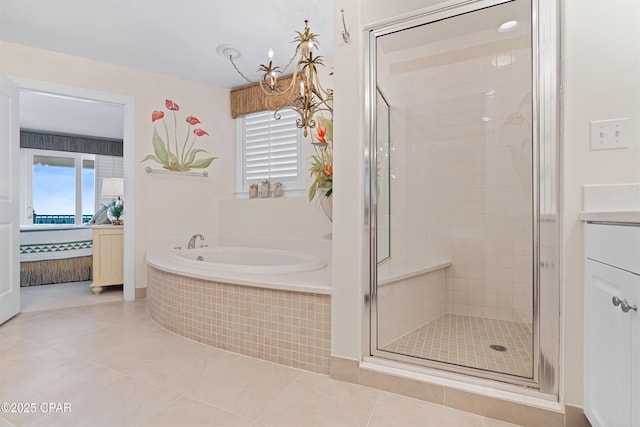 ensuite bathroom with a healthy amount of sunlight, a stall shower, a bath, and tile patterned floors