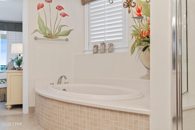 bathroom with a garden tub and tile patterned flooring