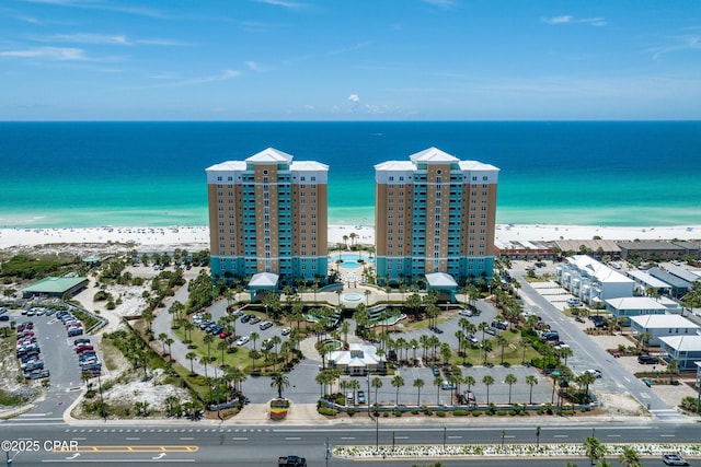 aerial view with a water view and a beach view