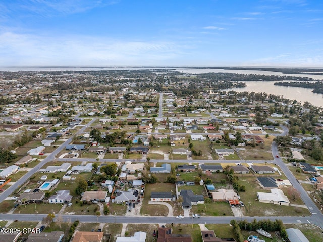 bird's eye view featuring a water view and a residential view