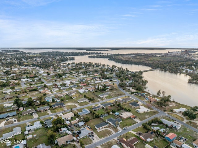 birds eye view of property with a water view and a residential view