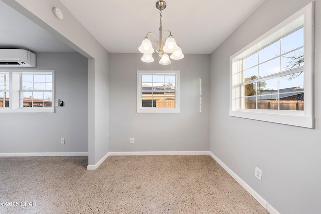 unfurnished dining area with baseboards, a wall mounted air conditioner, a notable chandelier, and a wealth of natural light