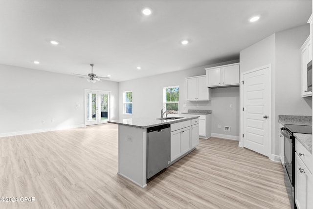 kitchen with a center island with sink, light stone countertops, black / electric stove, stainless steel dishwasher, and a sink