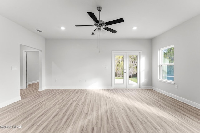 spare room with baseboards, visible vents, and light wood finished floors