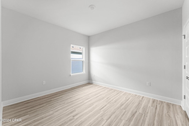 empty room with light wood-style floors and baseboards