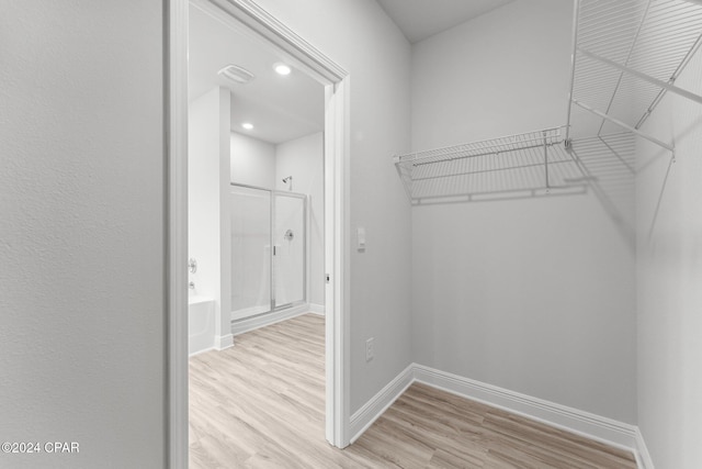 spacious closet featuring light wood finished floors