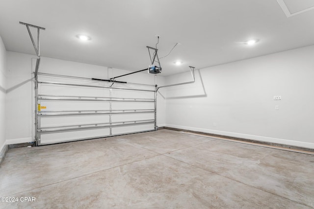 garage featuring a garage door opener, recessed lighting, and baseboards