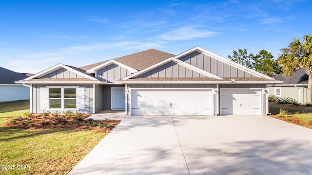 view of front of property with roof with shingles, concrete driveway, board and batten siding, a front yard, and a garage