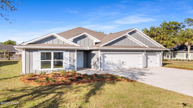 view of front of property with an attached garage, board and batten siding, a front lawn, and concrete driveway