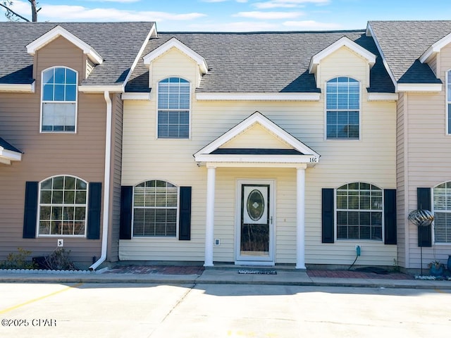 multi unit property featuring a shingled roof