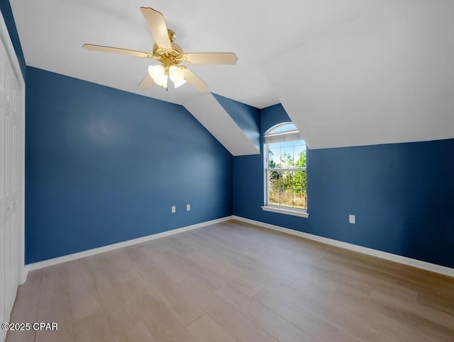 additional living space featuring ceiling fan, wood finished floors, lofted ceiling, and baseboards