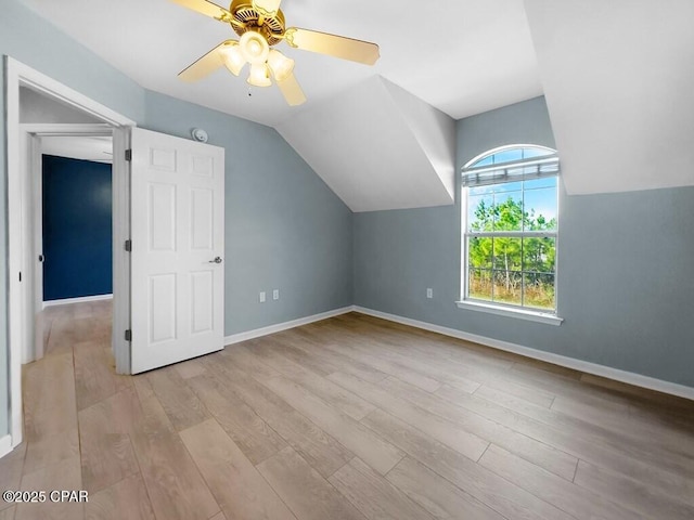 additional living space featuring a ceiling fan, lofted ceiling, baseboards, and wood finished floors