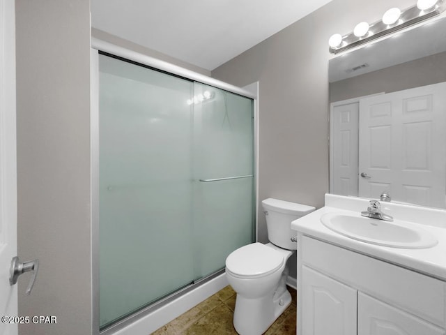 bathroom with a stall shower, visible vents, vanity, and toilet