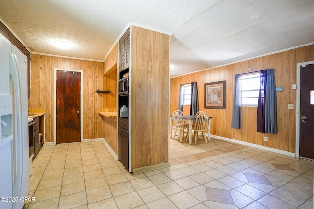 kitchen featuring white fridge with ice dispenser, crown molding, and wooden walls