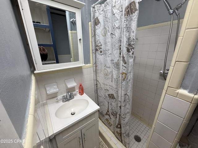bathroom with a stall shower, tasteful backsplash, tile walls, and vanity