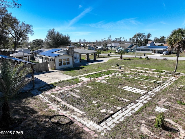 view of yard featuring fence and a residential view