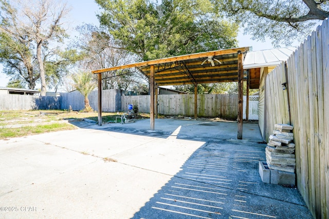 view of patio / terrace with concrete driveway and a fenced backyard