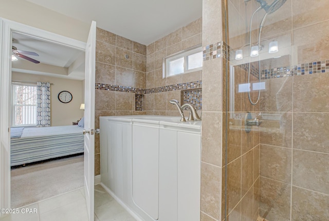 bathroom with ensuite bathroom, a sink, a walk in shower, and tile patterned floors