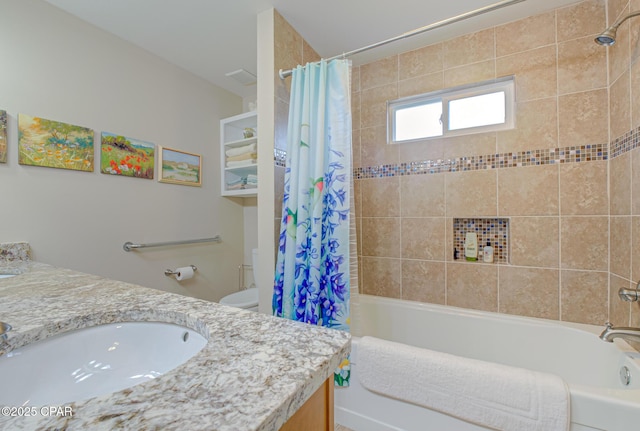 bathroom with visible vents, vanity, toilet, and shower / bath combo with shower curtain