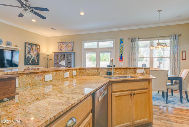 kitchen featuring a sink, light wood-style floors, crown molding, and dishwasher