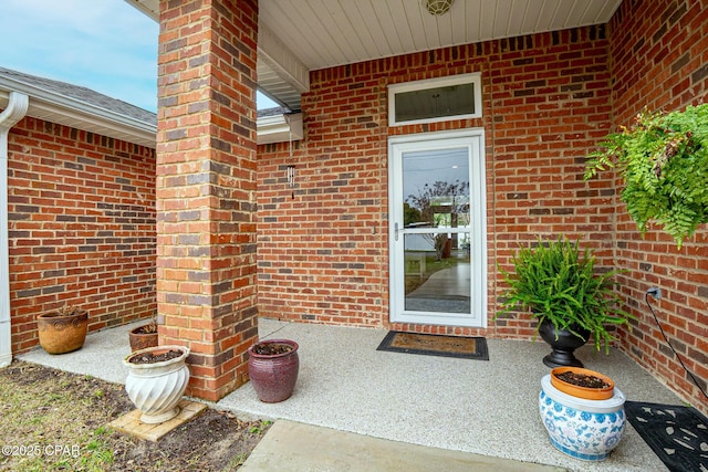 entrance to property featuring brick siding