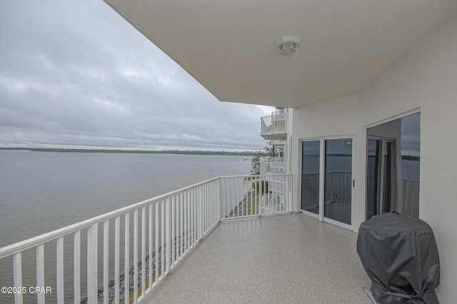 balcony with a water view and a grill