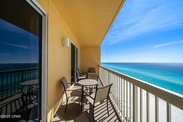 balcony with a view of the beach and a water view