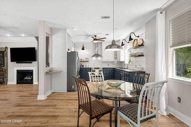 dining area with recessed lighting, baseboards, a healthy amount of sunlight, and light wood finished floors