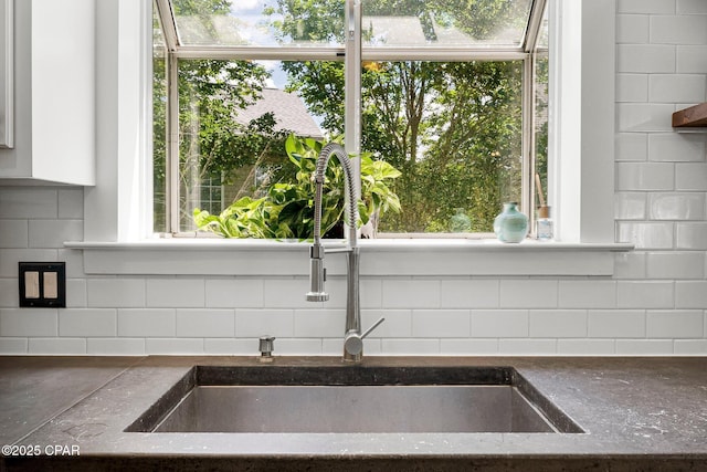 interior details featuring tasteful backsplash and a sink