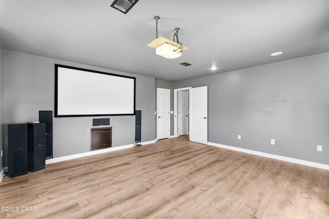 cinema with visible vents, baseboards, and wood finished floors