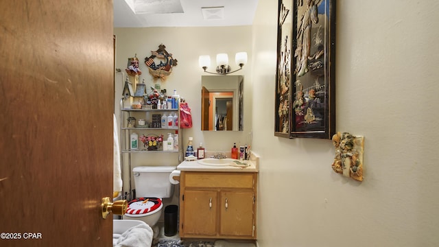 bathroom featuring toilet, visible vents, and vanity