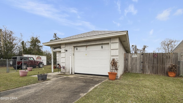 garage with driveway and fence