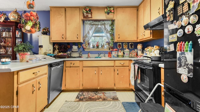 kitchen with light floors, under cabinet range hood, light countertops, black appliances, and a sink