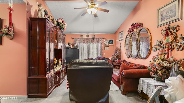 living room featuring light carpet, a textured ceiling, vaulted ceiling, and a ceiling fan