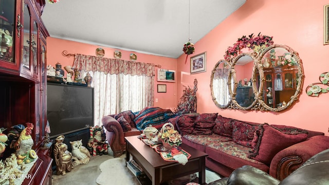 living area featuring vaulted ceiling and carpet flooring