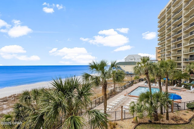 exterior space featuring fence and a beach view