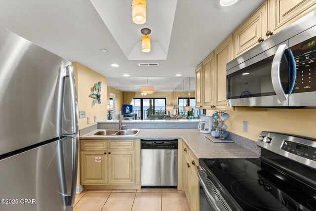 kitchen with light tile patterned flooring, a sink, visible vents, light countertops, and appliances with stainless steel finishes