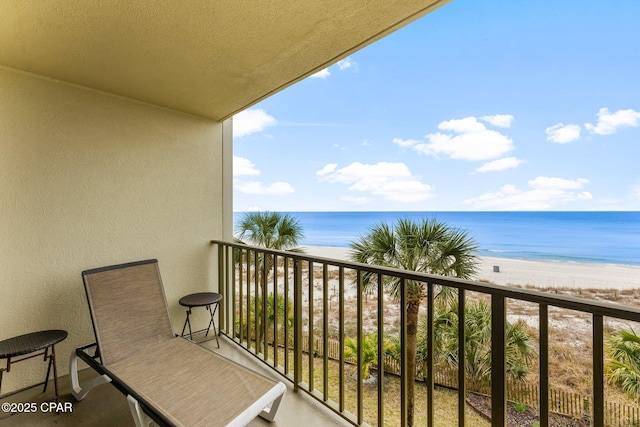 balcony with a water view and a beach view