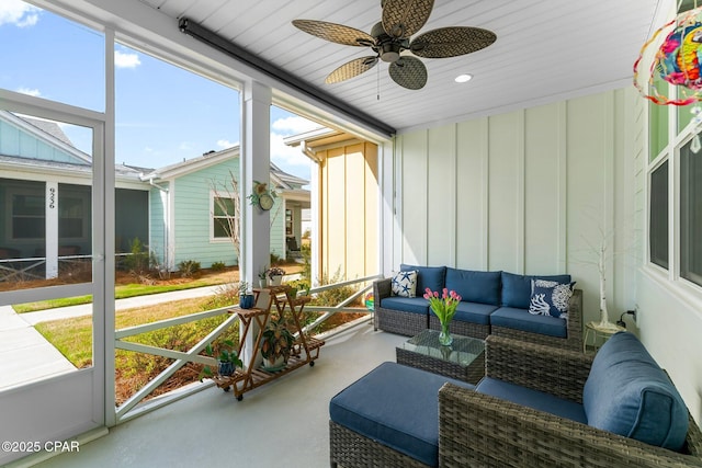 sunroom featuring ceiling fan and outdoor lounge area