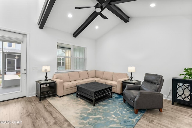 living room featuring a ceiling fan, recessed lighting, vaulted ceiling with beams, and light wood finished floors