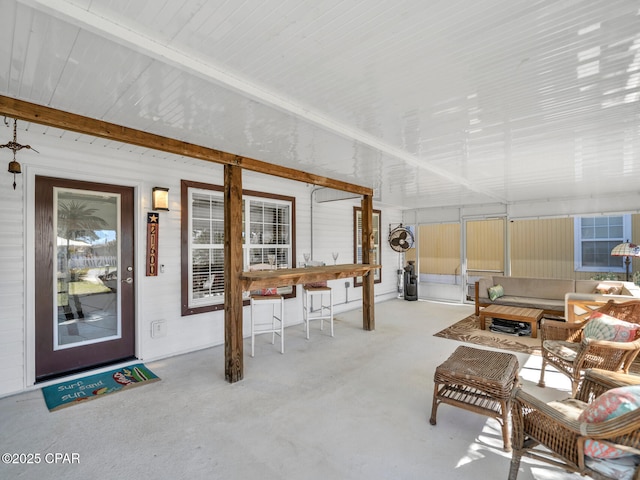 living area with concrete flooring