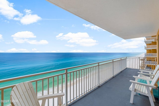 balcony with a view of the beach and a water view