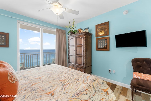 bedroom with baseboards, wood finished floors, access to exterior, and a ceiling fan