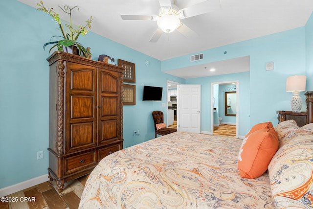 bedroom featuring visible vents, baseboards, and wood finished floors