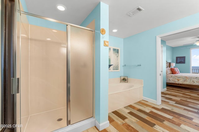 bathroom with visible vents, wood finished floors, a stall shower, and ensuite bathroom