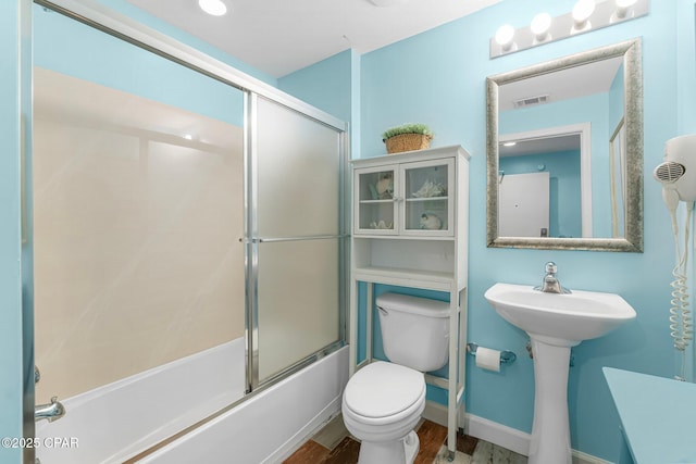 full bathroom featuring visible vents, baseboards, bath / shower combo with glass door, toilet, and wood finished floors