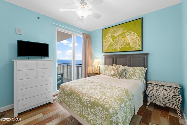 bedroom with a ceiling fan, access to exterior, wood finished floors, and baseboards